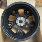 Durable matte black steel car wheel rim with a rugged multi-spoke design.
