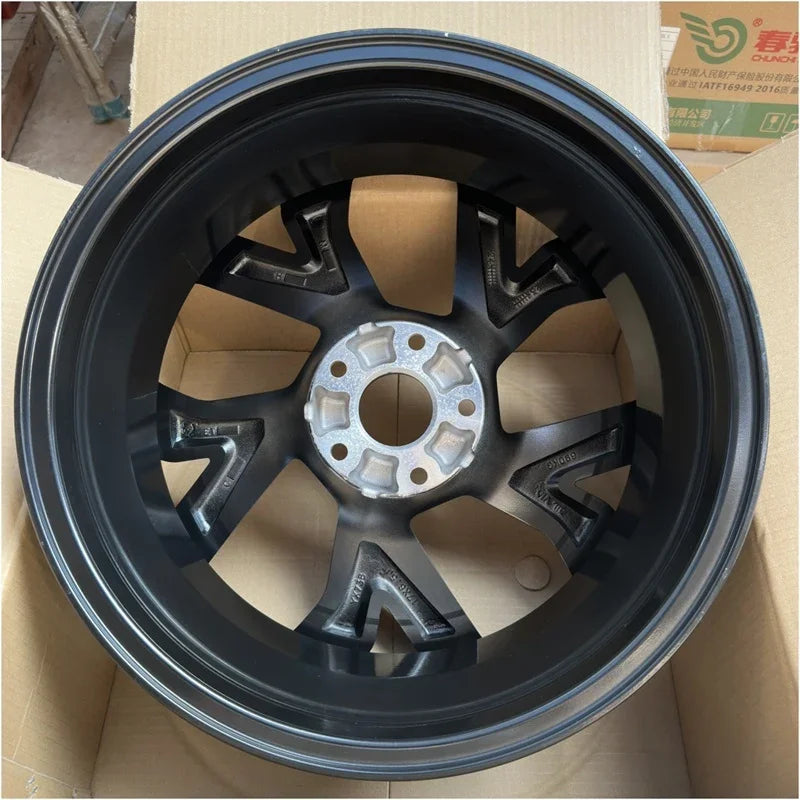 Durable matte black steel car wheel rim with a rugged multi-spoke design.