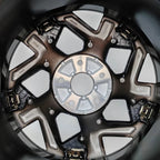 Black and bronze metallic alloy car wheel rim with multi-spoke design and silver center hub.