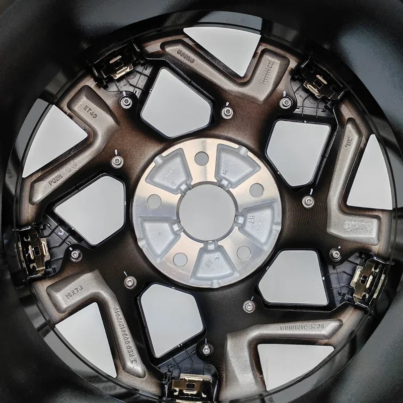 Black and bronze metallic alloy car wheel rim with multi-spoke design and silver center hub.