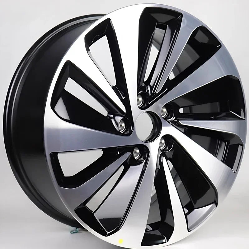 Two-tone silver and black machined alloy car rim with a multi-spoke aerodynamic design.