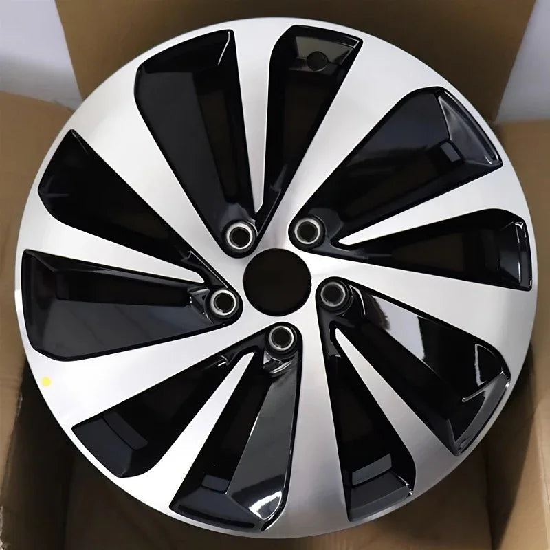 Black and silver two-tone aerodynamic car wheel cover with a glossy finish.