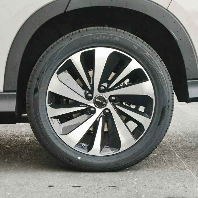 Black and silver multi-spoke alloy wheel with Giti tire on a white BYD vehicle.