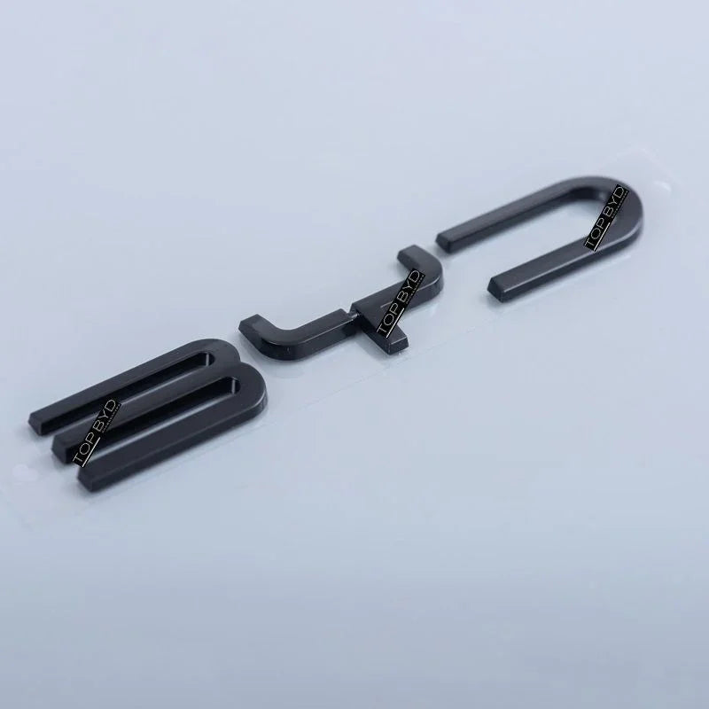 Professional matte black metallic BYD car emblem accessories on a white background