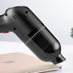 Black matte handheld vacuum cleaner with a transparent smoke-colored dust collection cup.