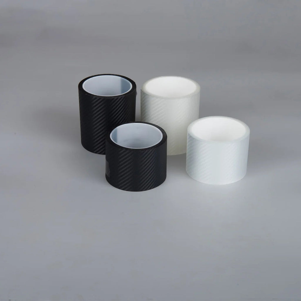 Three rolls of carbon fiber texture adhesive vinyl wrap in black and white colors.