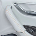 White leather car armrest cover with contrasting orange stitching for interior protection.