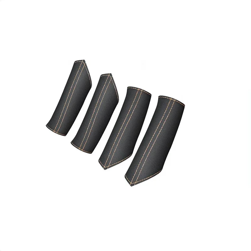 Set of four black faux leather car interior protectors with contrasting orange stitching.