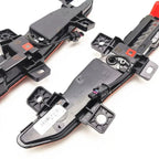 Black plastic door lock actuator assembly with red trim and electrical wiring components.