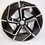 Black and silver dual-tone patterned car wheel hubcap with a sleek geometric design.