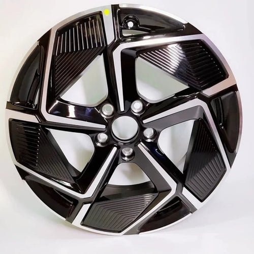 Black and silver dual-tone patterned car wheel hubcap with a sleek geometric design.