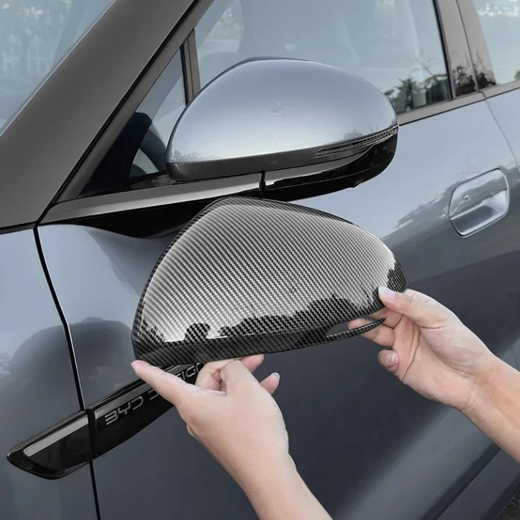 Grey carbon fiber side mirror cover for BYD car showing textured weave finish