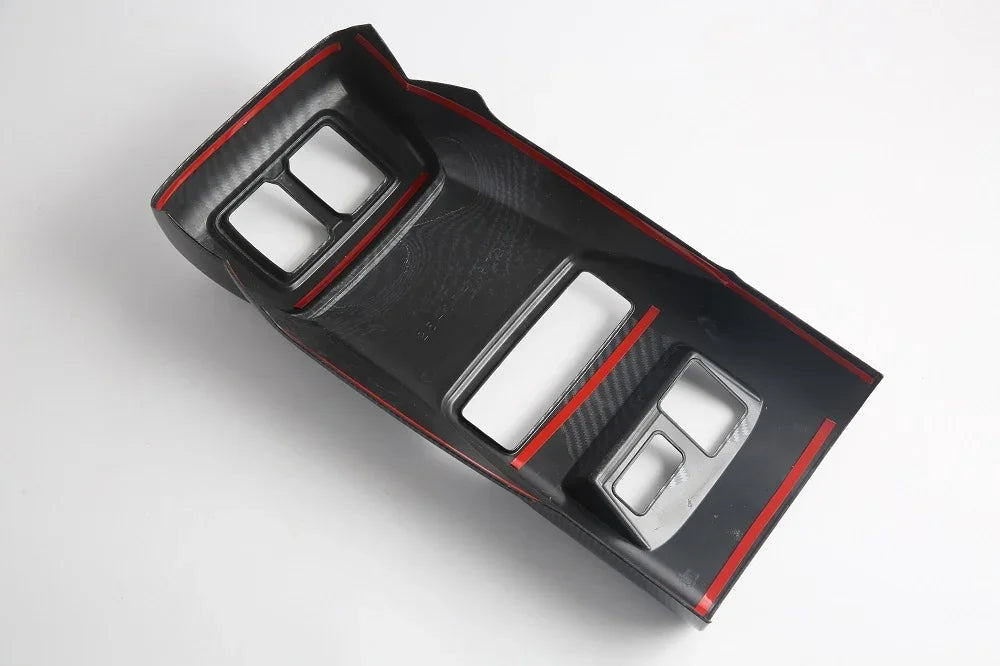 Black carbon fiber texture center console trim with striking red edge accents.