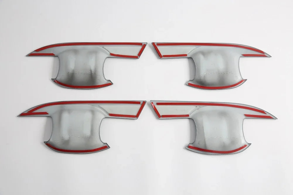 Set of four silver metallic car door sill protectors with distinctive red trim accents.