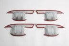 Set of four silver metallic car door sill protectors with distinctive red trim accents.