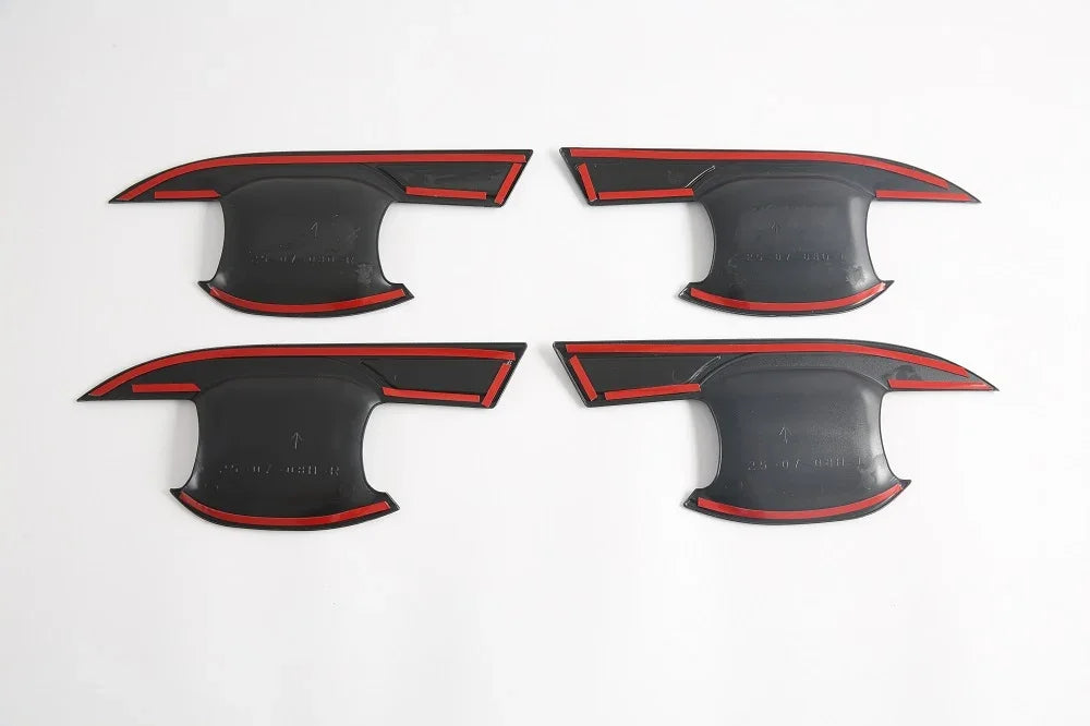 Four black matte door sill protector plates with distinctive red trim accents.