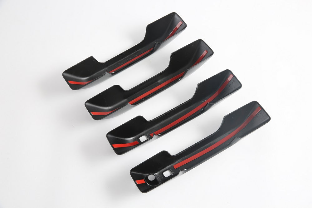 Set of four matte black interior door handle covers with sleek red racing stripes.