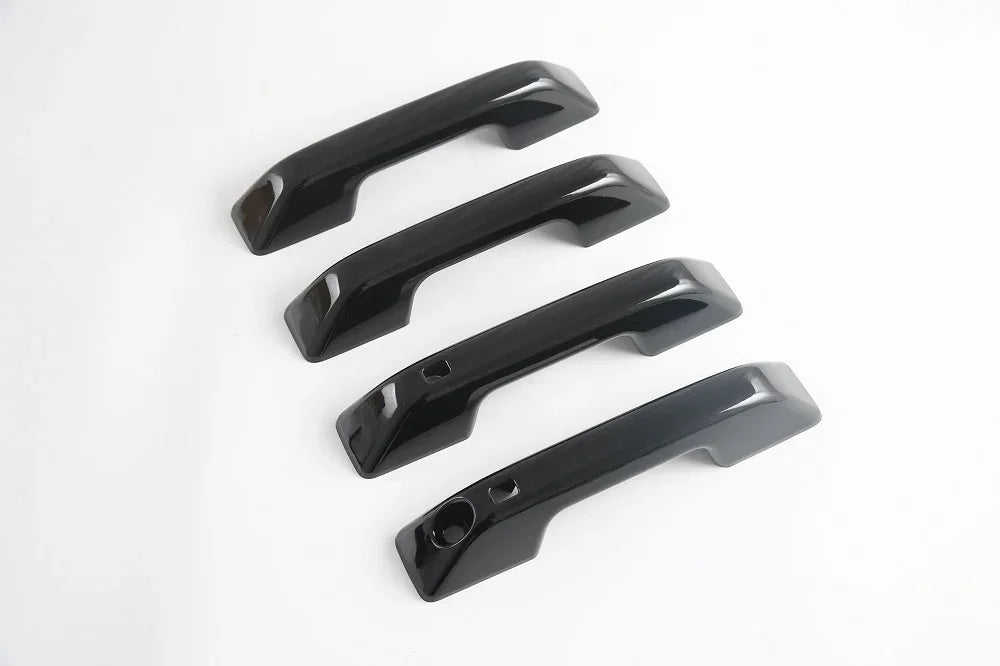 Set of four glossy black premium ABS plastic interior grab handles for BYD vehicles.
