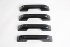 Set of four glossy black automotive door handle covers made of durable ABS material.