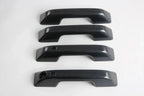 Four black carbon fiber texture door handle covers for BYD vehicle protection.