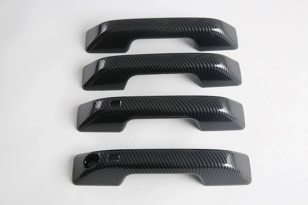 Four black carbon fiber texture door handle covers for BYD vehicle protection.