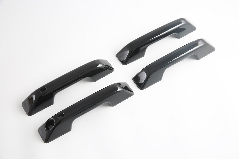 Four glossy black high-shine door handle covers for BYD vehicle protection.