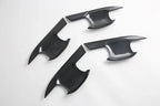 Black carbon fiber interior trim panels with a sleek glossy texture for BYD car accessories.