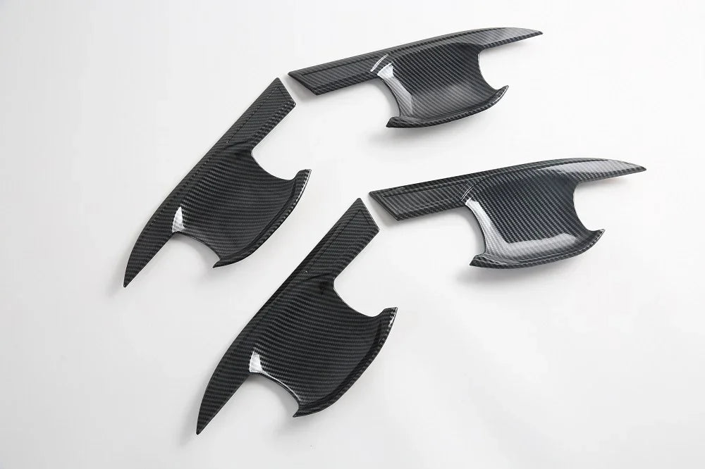 Black carbon fiber interior trim panels with a sleek glossy texture for BYD car accessories.