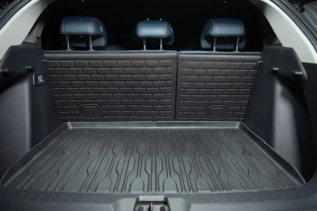 Black heavy-duty rubberized cargo mat and trunk liner protecting a vehicle's interior surface.