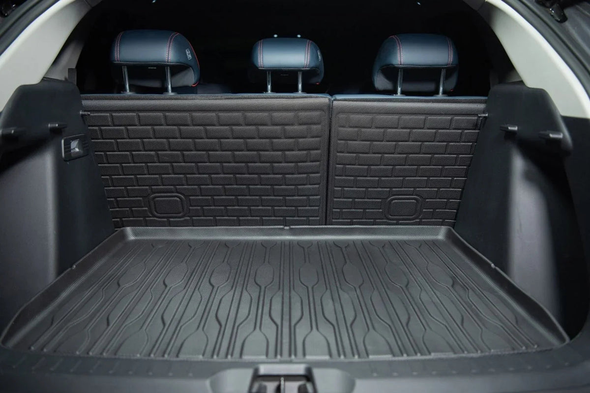 Black heavy-duty rubberized cargo mat and trunk liner protecting a vehicle's interior surface.