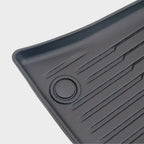 Close-up of a durable grey textured car floor mat with anti-slip ridges and reinforced grommet.