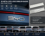 Close-up product image of a 3D black metal alloy emblem badge with a raised finish and adhesive backing, designed for rear trunk exterior customization on compatible BYD vehicles.