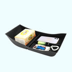Black durable plastic car organizer tray holding tissues, smartphone, and small accessories.