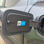 Black matte fuel filler door cover with a blue and white fuel type warning sticker.