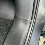 Black textured leather-like protective door sill trim for BYD car interior.