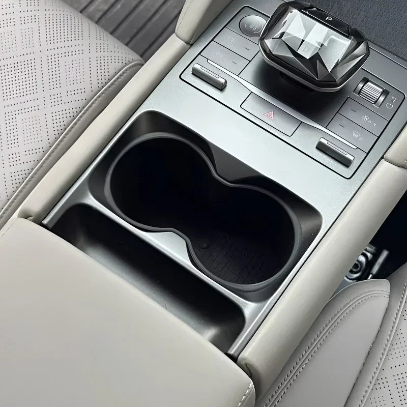 Grey center console featuring dual black cup holders and integrated control panel.