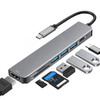 Professional silver aluminum USB-C hub with multiple ports, SD card slots and memory cards.