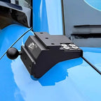 Black heavy-duty metal tow ball hitch mounted on a blue vehicle.