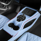 Light blue interior car console with custom-fit protective mats and sleek red trim accents.