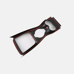 Black carbon fiber texture center console trim with striking red accent stripes.