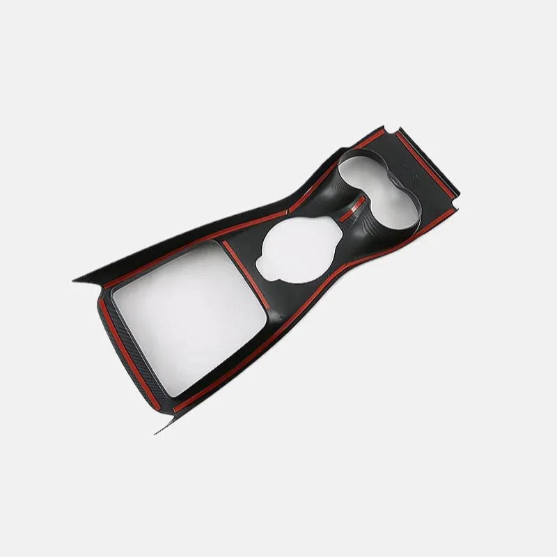 Black carbon fiber texture center console trim with striking red accent stripes.