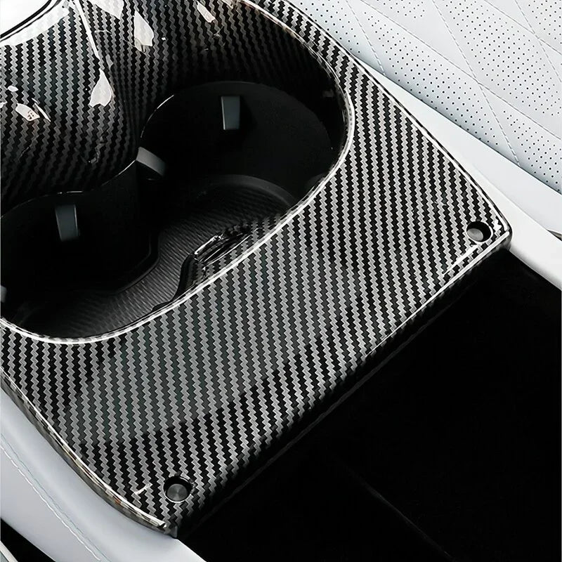 Carbon fiber pattern interior cup holder cover for BYD vehicles in black and grey.