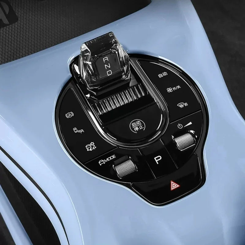 Crystal gear shifter and black control panel on a light blue BYD interior console.