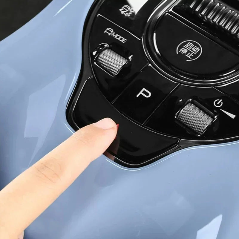 A person's finger pressing the sleek black glossy center console control panel of a BYD vehicle.