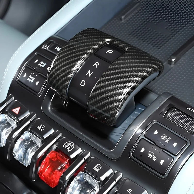 Carbon fiber gear shift cover with glossy black finish for BYD interior.