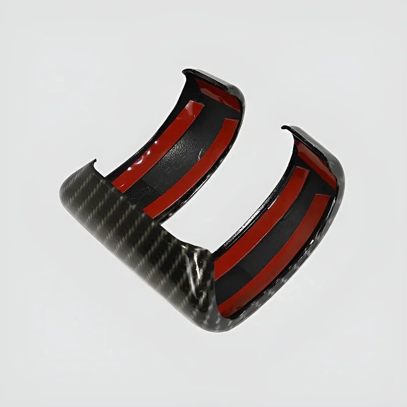 Carbon fiber car accessory with a distinctive red and black interior finish.