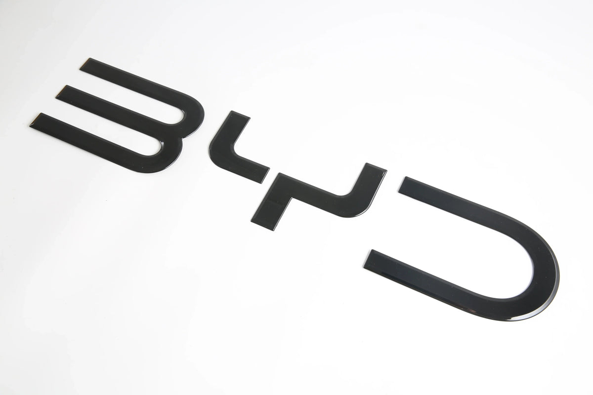 Glossy black BYD emblem badge made of premium high-shine material for car exterior decoration.