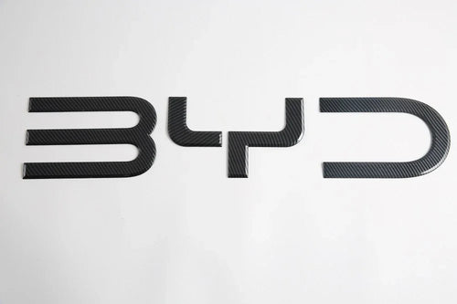 Black carbon fiber textured BYD emblem for car exterior decoration.