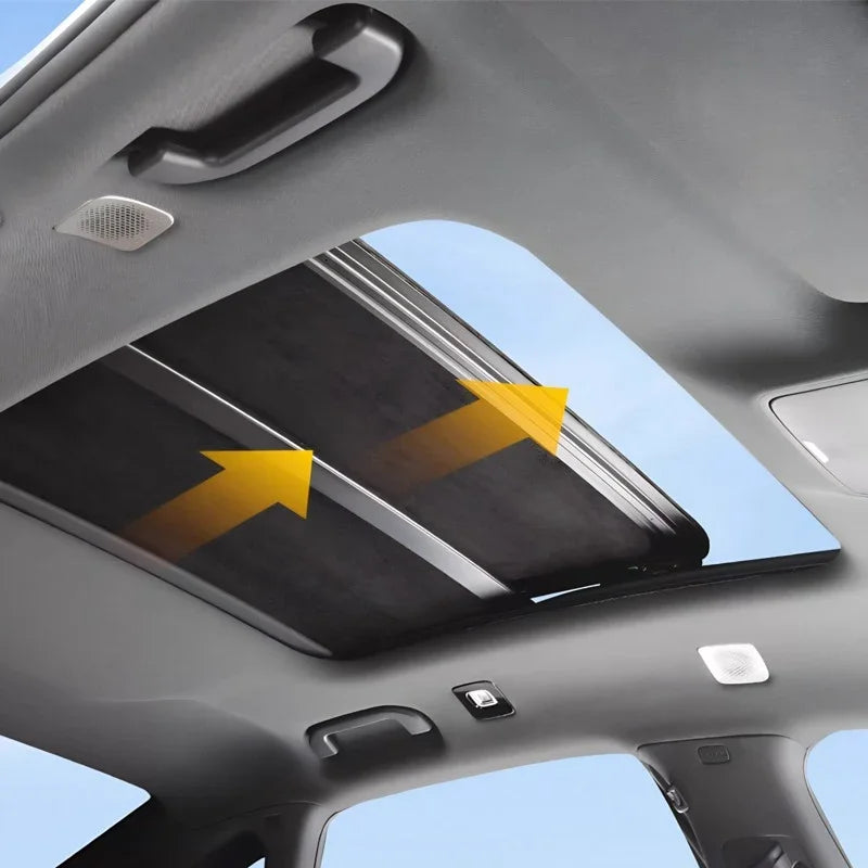 Black mesh sunroof shade installed on a car panoramic glass roof for heat protection.