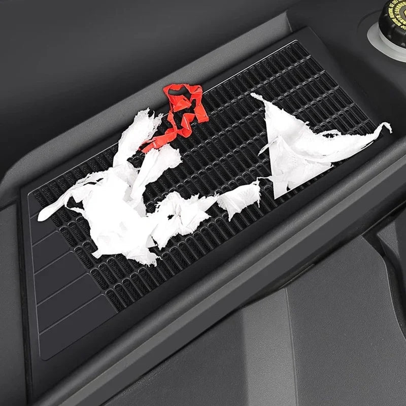 Black textured rubber car tray mat protecting the console from spills and debris.